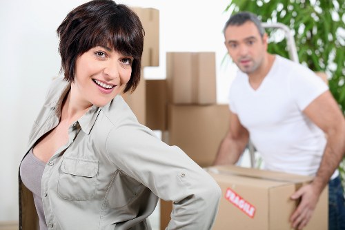 Removalists organizing and labeling moving boxes